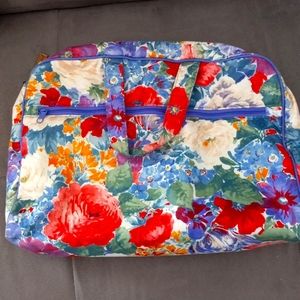 Cosmetic travel bag.  Floral print.  Zip closure .  Measurements 14inchx15inch.